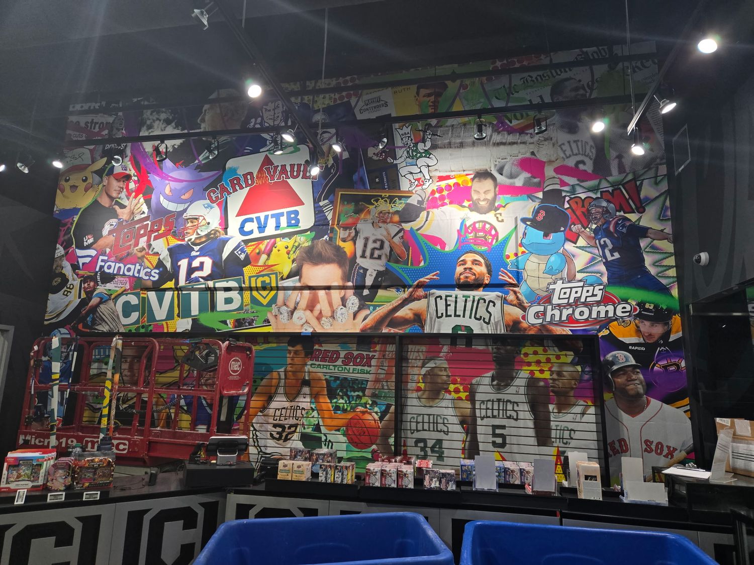 Card-collage feature wall behind the register at CardVault