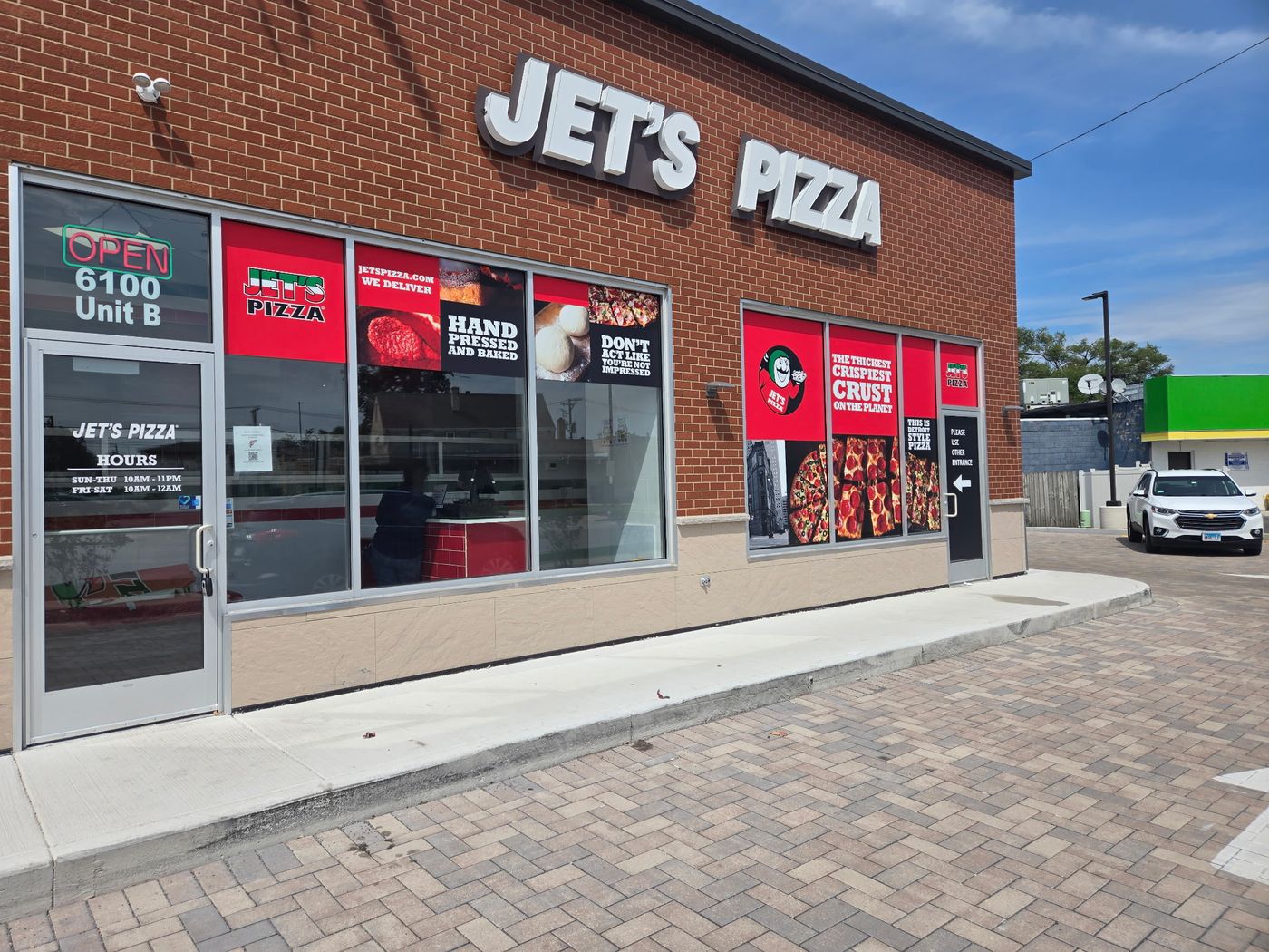 Jet's Pizza storefront with full window graphics package