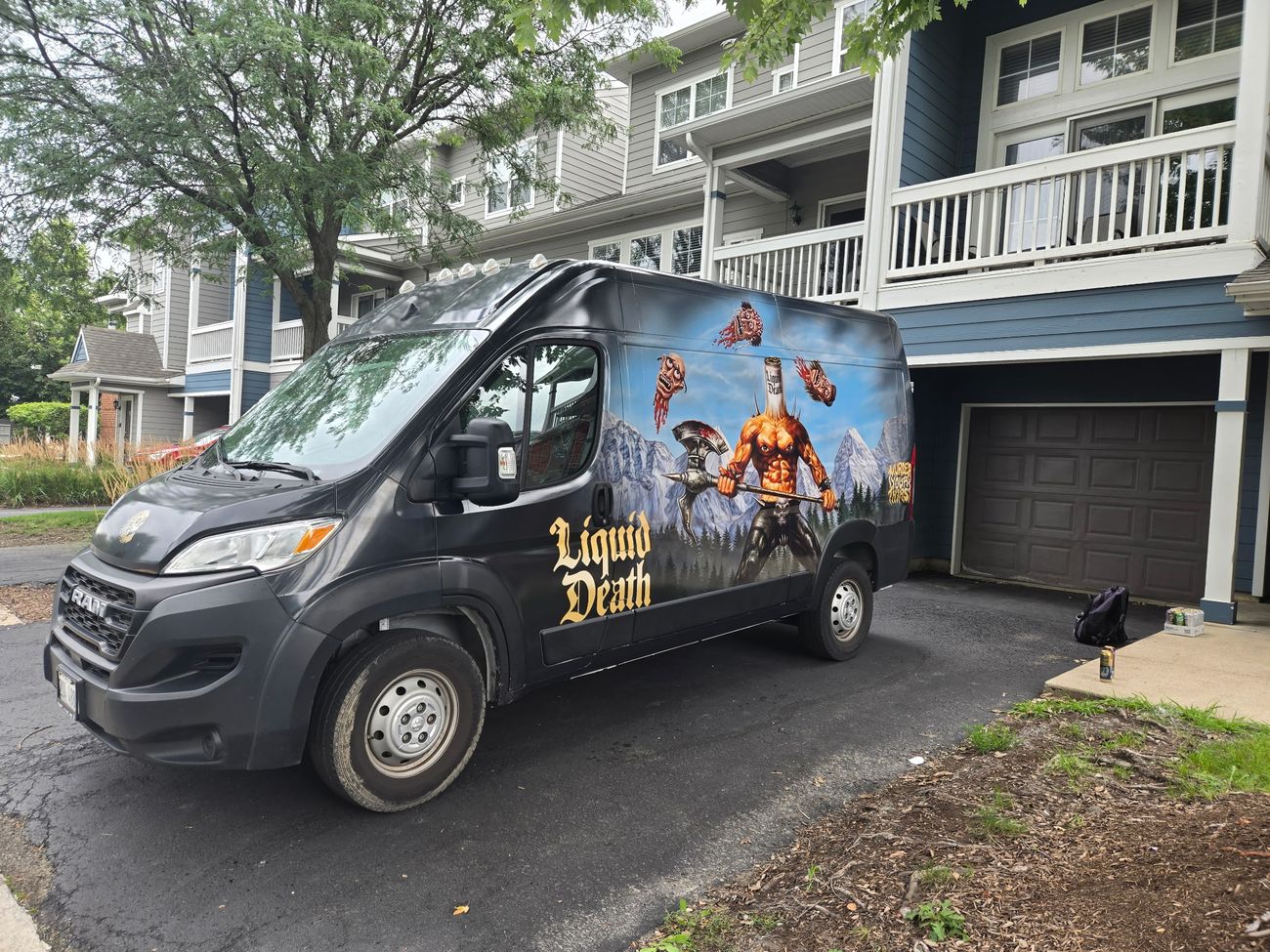 Liquid Death van front three-quarter view on delivery route
